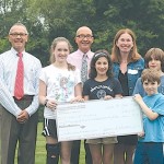David Evangelisti, Dan Taylor-Stypa and Denise D'Avella gratefully accept a check from Essex Elementary School students