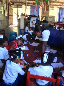 Teacher working with the students using manipulatives and "found" objects