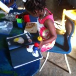 Early Education students in Deschapelles, Haiti, working with hands on manipulatives for learning