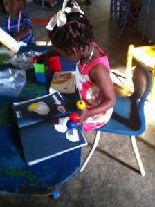 Early Education students in Deschapelles, Haiti, working with hands on manipulatives for learning